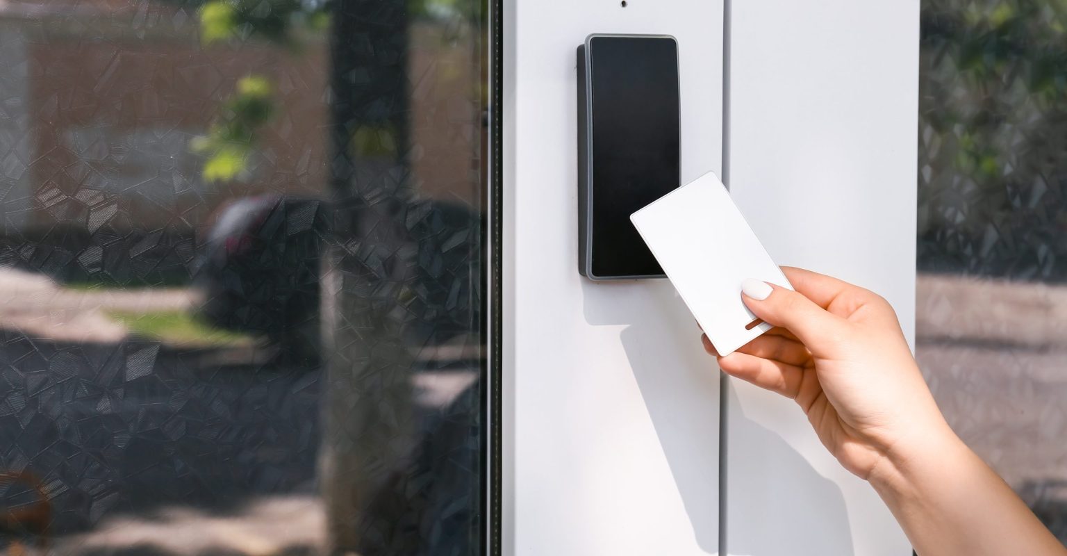 Woman using card to open door outdoors